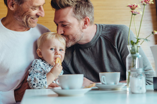 Couple with baby boy sitting in cafe
