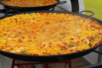Freshly Made Paella Being Cooked in Large Pans.