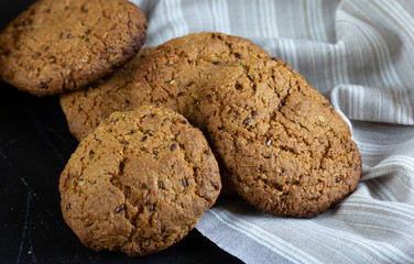 Homemade oatmeal cookies in basket with linen napkin
