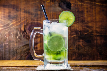 Beer caipirinha. Brazilian exotic drink of beer with lemon and cachaça.