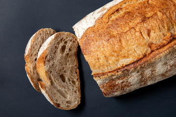Fresh sliced ​​bread on a black background. View from above