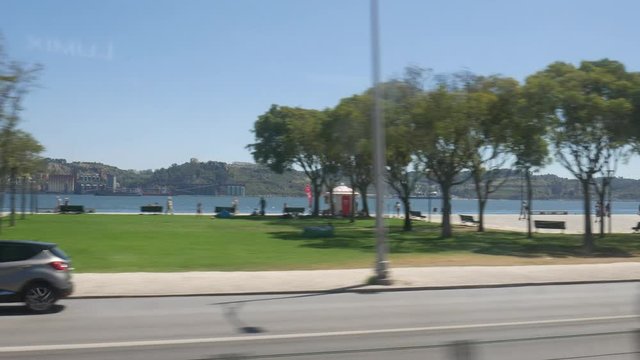 POV Train Ride In City of Lisbon, Window View along Tagus River on a beautiful sunny day.