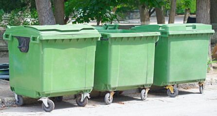 three green garbage containers