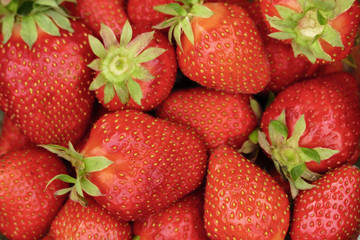Organic strawberries closeup background, top view