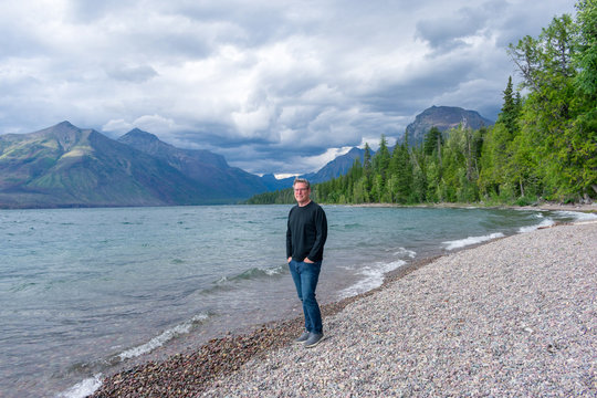 Man enjoying the scenic view at Lake McDonald in Glacier National Park