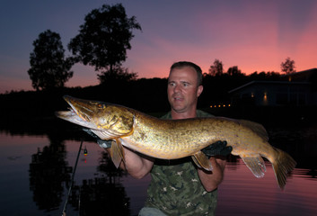 Big pike fishing at the dusk