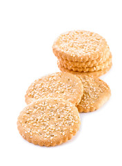 group of cookies with grains of sugar and sesame seeds close-up isolated on white background