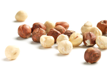 hazelnut nuts scattered on white paper background