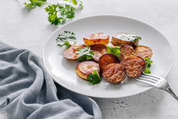 Baked potatoes with cilantro in a plate