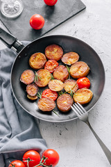 Baked potatoes with cilantro in a pan
