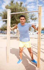 Man training on outdoors fitness station