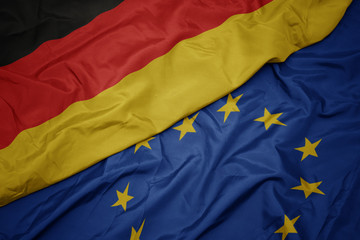waving colorful flag of european union and national flag of germany.