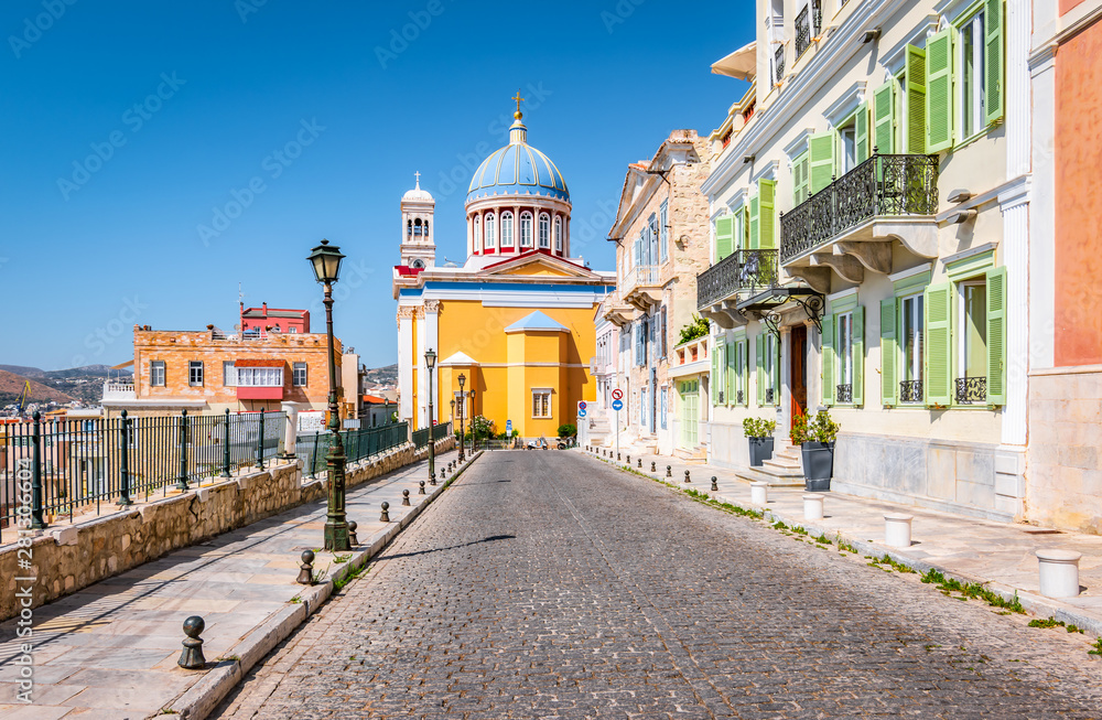 Poster Street with colorful buildings in town center of Ermoupoli, Syros, Greece.