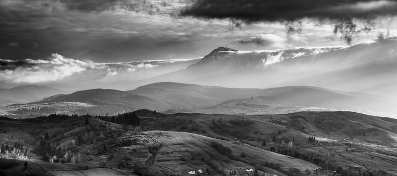 Amazing Carpathian  panoramic landscape of  misty mountain hills and cloudy sky in black and white. Ukraine.