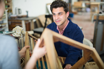 Carpenter taking chair for repairing