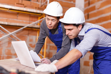 Workers looking at laptop