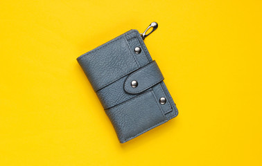 Fashionable leather wallet on yellow background. Top view