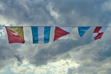 naval flags fluttering in the wind against the sky