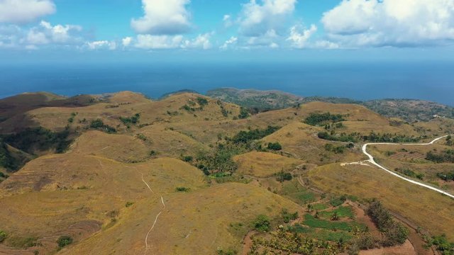 Teletubbies Hill View to The Sea. Drone Shot Tropical Savanna Hills at Nusa Penida, Bali - Indonesia