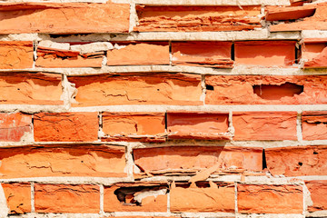 An old dilapidated wall from old bricks