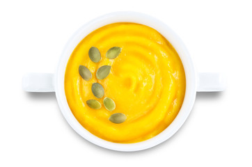 Pumpkin soup in white bowl on a white isolated background