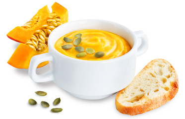 Pumpkin soup in white bowl on a white isolated background