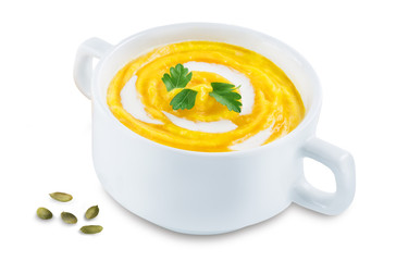 Pumpkin soup in white bowl on a white isolated background