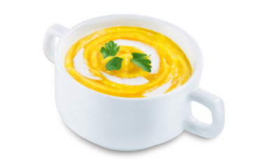 Pumpkin soup in white bowl on a white isolated background