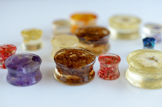 Ear piercing (plugs, tunnels, gauges) of epoxy resin close-up.