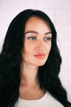 Portrait of brunette girl without retouching, visible skin problems