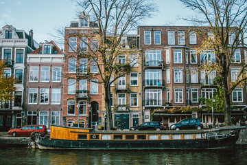 Amsterdam canal with a boat and houses