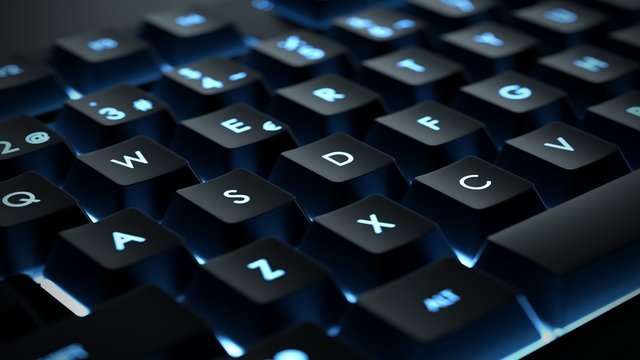 Backlit keyboard close up. Black keys with illuminated characters.