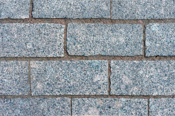 Texture of the wall and gray granite bricks.