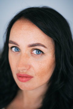 Portrait of brunette girl without retouching, visible skin problems