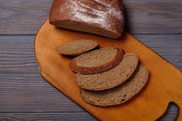 Rustic bread loaf on dark background. Top view