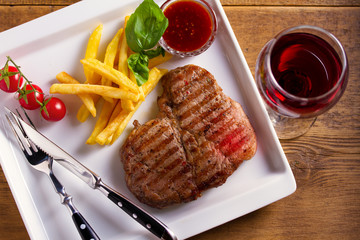 Grilled steak and glass of red wine. Food and wine. View from above, top studio shot