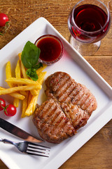Grilled steak and glass of red wine. Food and wine. View from above, top studio shot