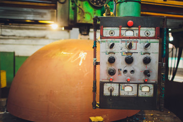 Workers in a foundry grind castings with a grinding machine - Heavy industry workplace.