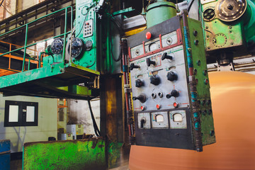 Workers in a foundry grind castings with a grinding machine - Heavy industry workplace.
