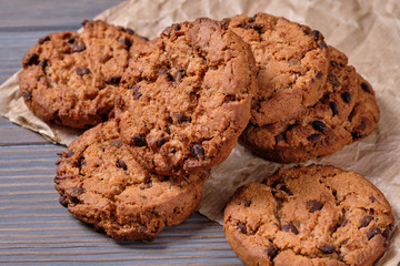 Chocolate oatmeal chip cookies on the rustic wooden table.