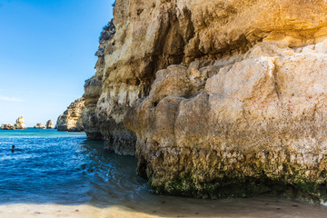 Fototapeta na wymiar Cliffs and rocky caves on Dona Ana beach in Lagoa, Algarve (Portugal)