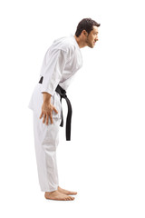 Man in karate kimono with black belt ducking his head © Ljupco Smokovski