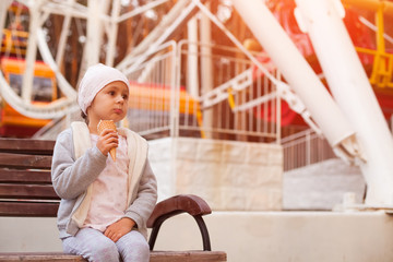 Little girl eating ice-cream in the park