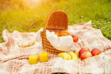 Obraz na płótnie Canvas Croissant basket and fruit picnic outdoors in the park