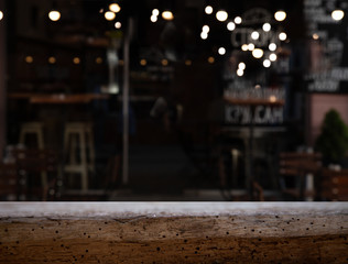 vintage wooden table on blurred cafe background dining room restaurant
