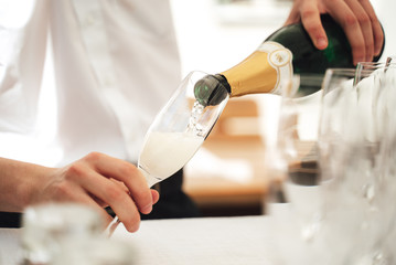 Waiter serving a flute of champagne