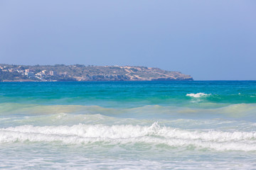 Beautiful blue turquoise water and seashore with waves and foam