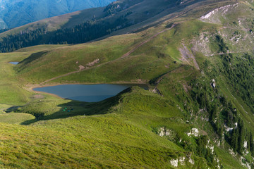 Landscape of wonderful glacier Vinderel Lake. Mountain Maramures Nature Park. Natural reserve. Carpathian. Romania. Europe.