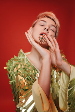 Young woman with jewelry cross in mouth