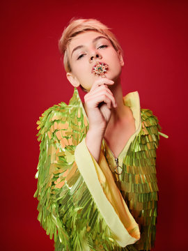 Young woman with jewelry cross in mouth